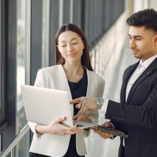 Handsome man in a black suit. Businessman working in a office. Woman with her partner.