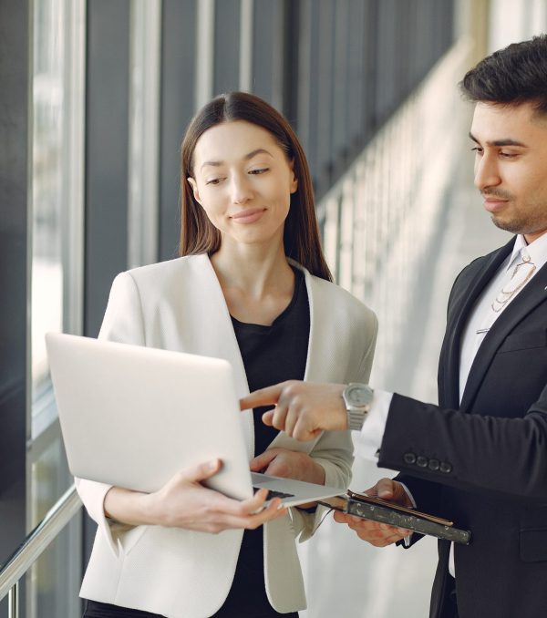 Handsome man in a black suit. Businessman working in a office. Woman with her partner.