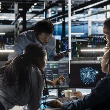 Data center engineering team implements AI virtualization frameworks to optimize server clusters. Teamworking server hub colleagues do artificial intelligence predictive analysis